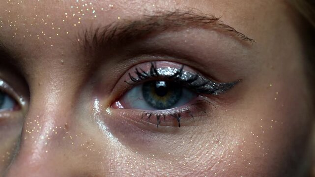 Reacting to light shift, model's right eye blinking briefly then opening, showing silver liner