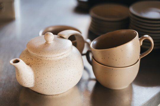 Clay teapot and mugs. Handcrafted tea set in a minimalist style.