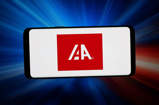 Stuttgart, Germany - 07-15-2026: In this photo illustration, the logo of US vehicle marketplace company IAA Inc. is displayed on a smartphone in front of abstract background on computer screen.