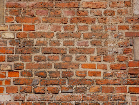 A fragment of old red brickwork. Construction work in medieval Europe.