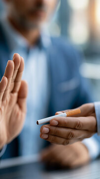 Faceless man making a stop gesture with his hand to refuse a cigarette, quitting smoking concept, willpower and health choice, with copy space
