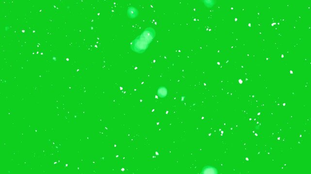 White snowflakes gently falling against a vibrant green background create a smooth winter atmosphere animation ideal for festive holiday themed motion design and video editing projects.