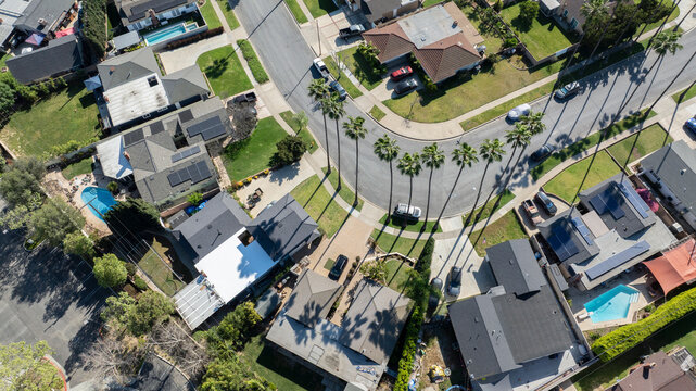 Palm trees frame an aerial view of a neighborhood in Yorba Linda, California, USA.