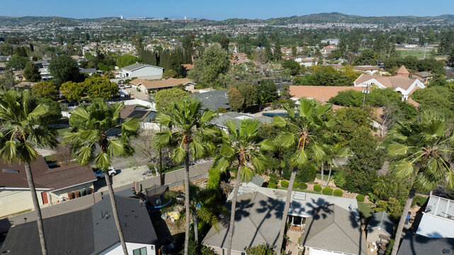 Palm trees frame an aerial view of a neighborhood in Yorba Linda, California, USA.