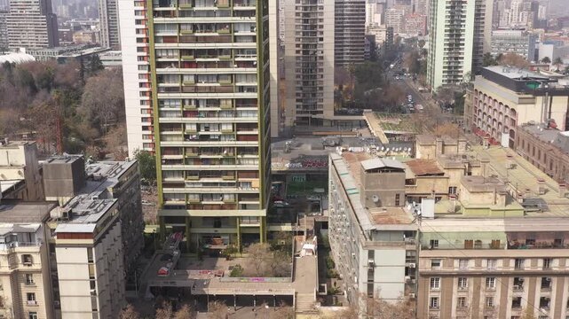 Aerial view of a unique triangular red residential building at a street intersection in Santiago de Chile