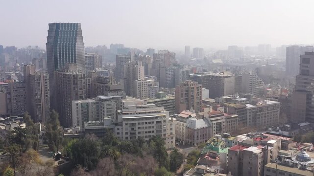 Aerial view of a unique triangular red residential building at a street intersection in Santiago de Chile
