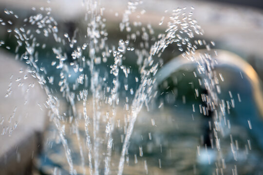 close-up shot of a water fountain in a garden. selective focus on water droplets suspended in the air.