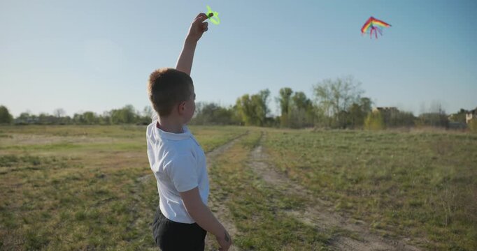 Children with mother flying a kite. Family spend time together on nature. 4K 10-bit