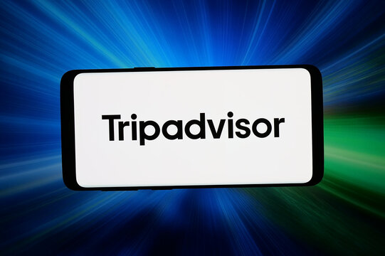 Stuttgart, Germany - 07-15-2026: In this photo illustration, the logo of US travel services company Tripadvisor Inc. is displayed on a smartphone in front of abstract background on computer screen.