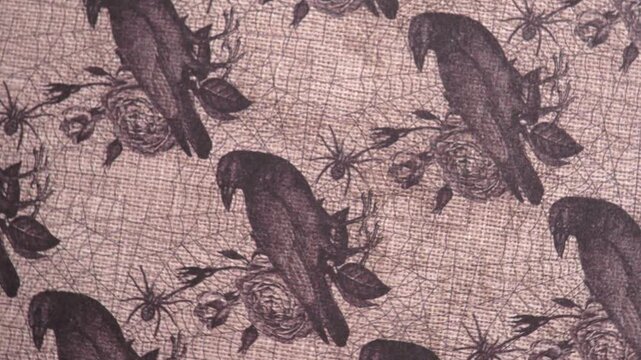 Rotating Close Up Shot of Gothic Raven and Rose Patterned Paper, halloween rotating background