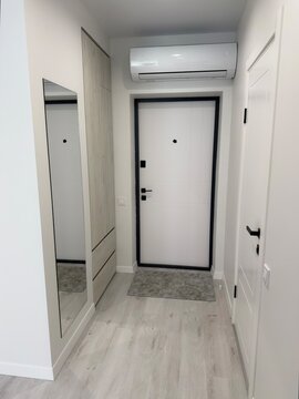 Modern Apartment Entryway Interior with Wardrobe Mirror and Air Conditioner