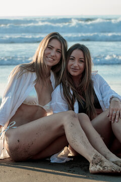 Two young women enjoying friendship and summer vacation on beach