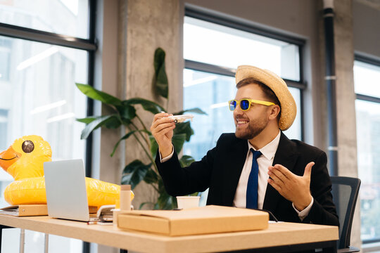 Businessman dreaming of tropical vacation with toy airplane