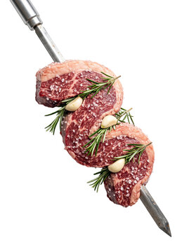 Raw beef steaks on metal skewer with rosemary and garlic seasoning PNG Isolated on transparent background
