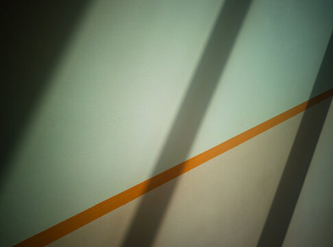 Dramatic diagonal beams of light on the office wall background