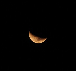 Sharp Crescent Moon in Pitch Black Night Sky: A high-contrast, close-up photograph capturing a crisp, bright silver crescent moon suspended in a completely dark, pitch-black night sky. The clean, mini © Abraham