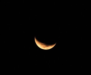 Sharp Crescent Moon in Pitch Black Night Sky: A high-contrast, close-up photograph capturing a crisp, bright silver crescent moon suspended in a completely dark, pitch-black night sky. The clean, mini © Abraham