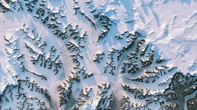 Flying above nunataks, glaciers and snow. Camera is zooming in, rotating counterclockwise. Animation based on image by NASA