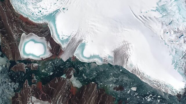 Aerial view on icy land and water covered with pieces of ice. Camera is moving backward and right. Animation based on image by NASA