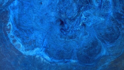 Mixing different colors of alcohol ink on a surface in a creative space © Mari Dein
