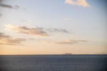 Fototapeta premium Dusk Sky Over a Silhouetted Tropical Island