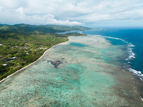 Aerial View of a Coastal Reef and Village