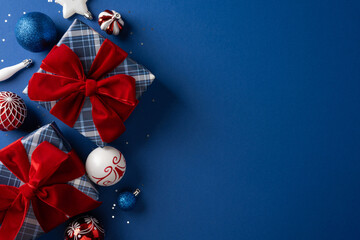 Naklejka premium Christmas gift flat lay with red velvet bows and festive ornaments on blue background for New Year