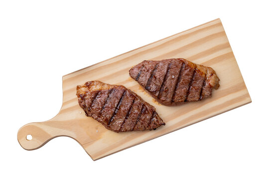 Grilled picanha beef over wooden board with vinaigrette isolated over white background