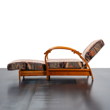 1930s reclining armchair, featuring a wooden frame with curved armrests and an adjustable mechanism.