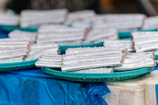 Salted cutlassfish piece group in basket displayed on street traditional seafood market stand in south korea.
