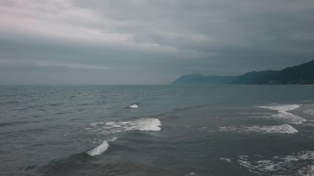 Gray waves lapping onto the shore