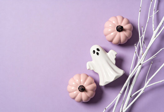 Pastel halloween decor, white ghost figurine, pink pumpkin decorations, spooky autumn tabletop display, halloween home ornament, pastel holiday styling, festive seasonal flatlay, party aesthetic.