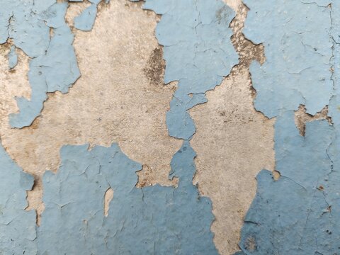A distressed wooden surface featuring random peeling paint, chipped layers, cracks, scratches, and naturally weathered wood grain. The irregular worn texture creates a rustic, vintage, and aged appear