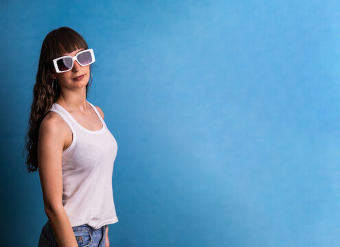 Stylish woman wearing white sunglasses posing casually