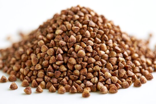 Heap of raw buckwheat groats isolated on white background