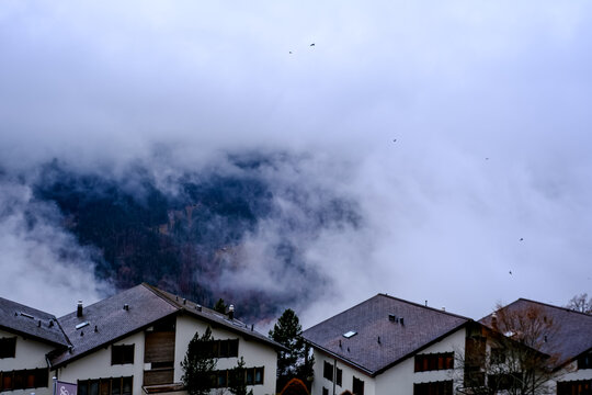 Wengen, Switzerland - 11.03.2026. An atmospheric, high-angle view of alpine chalets in the car-free village of Wengen, situated in the Bernese Oberland region of Switzerland. Traditional dark-roofed h