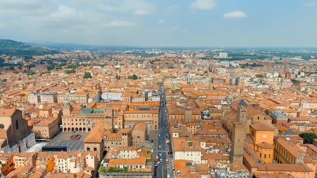 Bologna, Italy. The Two Towers, Torre degli Asinelli and Torre Garisenda, medieval stone towers rising above terracotta rooftops, Drone footage under clear summer sky. Drone footage, Departure of the