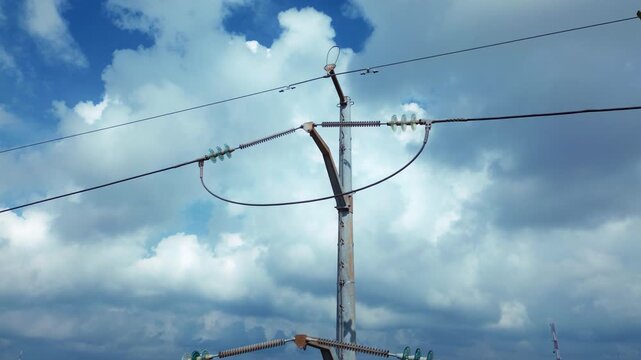 Drone aerial view of electrical transmission pole featuring cable infrastructure and attachment hardware with orbital camera movement