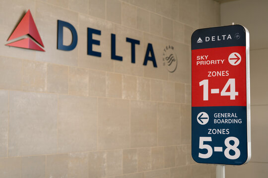 Detroit, Michigan, USA - 31 May 2026 : Delta airlines boarding sign at Detroit DTW airport terminal gate against the official Delta logo, mounted on tiled wall.