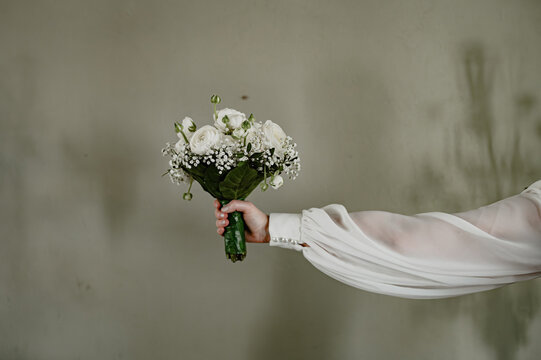 Bridal bouquet, hand, outstretched, a beautiful floral arrangement decorating a wedding.