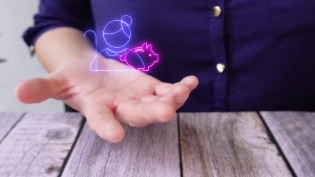 Financial goals. Close-up of a woman's hand at a table holding a virtual icon of an elderly woman with a piggy bank.