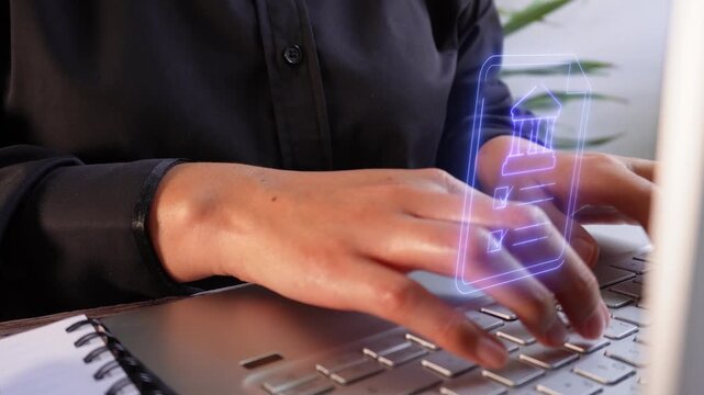 A person types on a laptop, with a blue virtual icon of a bank document.