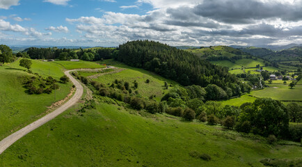 An aerial perspective of the lush green pastures and winding lanes looking towards Llansilin near Oswestryl on the border of Shropshire and Wales. © steheap