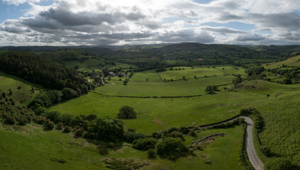 An aerial perspective of the lush green pastures and winding lanes looking towards Oswestry on the border of Shropshire and Wales. © steheap