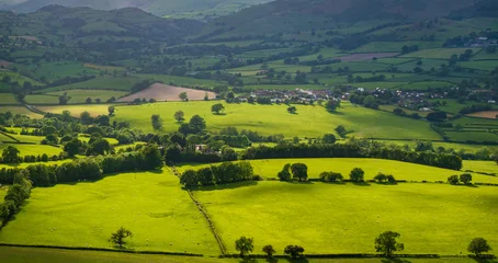 An aerial perspective of the lush green pastures and winding lanes looking towards Llansilin near Oswestry on the border of Shropshire and Wales. © steheap