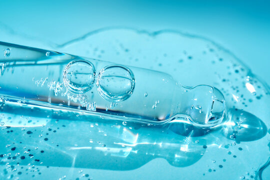 Cosmetic serum pipette extracting moisturizing liquid droplets