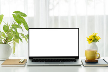 Laptop white screen and yellow cup with notebooks arranged on white table © paladin1212
