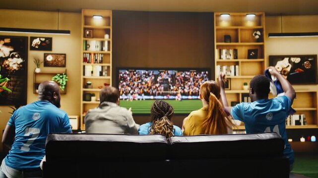 Angry football supporters scold players after a missed goal scoring chance while frustrated soccer fans show negative body language after loss.