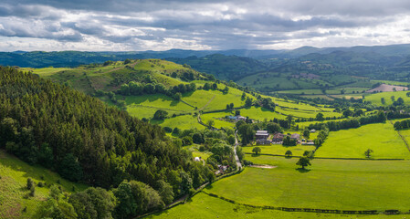An aerial perspective of the lush green pastures and winding lanes looking towards Llansilin near Oswestry on the border of Shropshire and Wales. © steheap