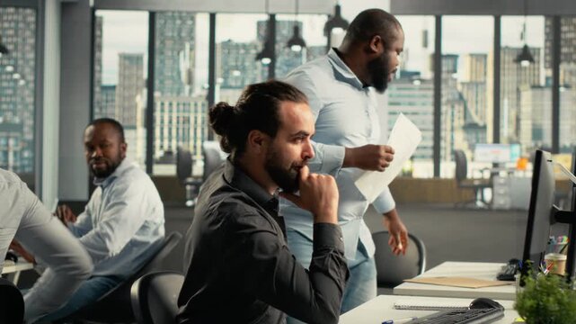 Work team review forecasting data inside a modern office, combining forecasting data while they connect analytics with management goals for a focused business workflow.